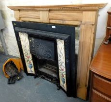 A pine fire surround and a metal fire surround, designed in the Art Nouveau style with tiles flankin