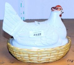 A Staffordshire hen on nest egg container.