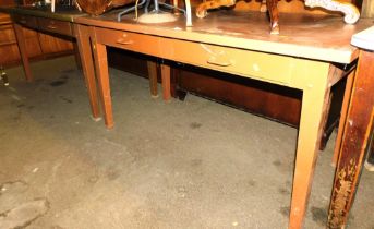 A pair of mid century industrial metal work tables, with two frieze drawers, raised on square legs.