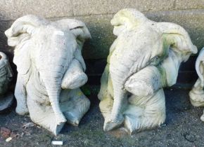 Two garden ornaments in the form of seated elephants.