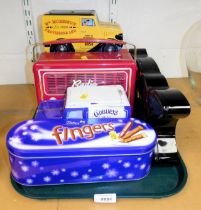 Four biscuit tins, in the form of a radio, two vehicles and a butterfly.