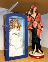 A boxed doll and a large wooden painted figure of a Deco style lady. (2)