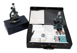 A Marlux student's microscope, 20cm high, cased, together with a further student's microscope, in pr