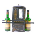 A novelty wine bottle stand, formed as a coach with two wine bottle sections, hold The Grants of St