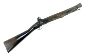 An 18thC flintlock blunderbuss by Barnett of London, with brass barrel, steel ram rod, brass trigger