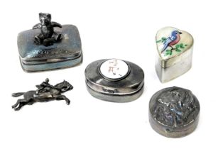 Four white metal pill boxes, comprising one with articulated bear to top, another with transfer prin