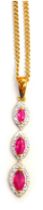 A 9ct gold ruby and diamond pendant and chain, the layered rubies of marquise shaped design, centred