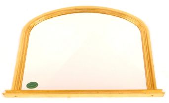 A 20thC giltwood wall mirror, of arched form, on moulded rectangular base, 78cm high, 99cm wide.