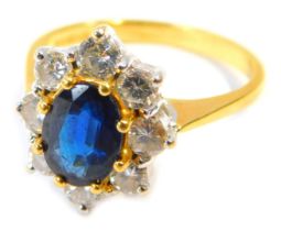 An 18ct gold, sapphire and diamond cluster ring, with oval set sapphire, 7.8mm x 5.6mm x 2.6mm, in e