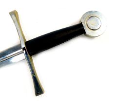 A reproduction medieval broad sword, with circular steel pommel, black leather hand grip and straigh