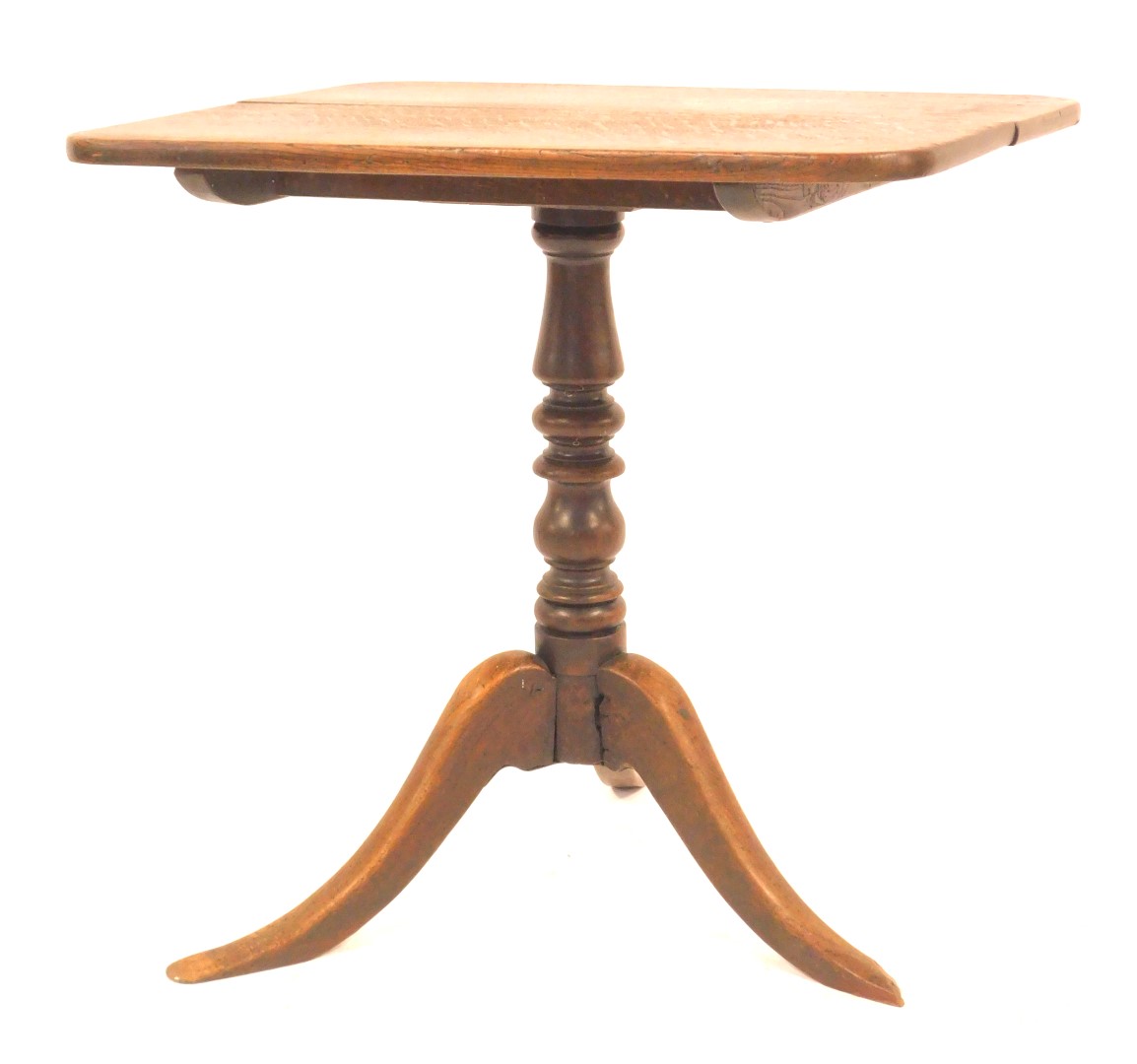 A 19thC oak tilt top table, the rectangular top with a rounded edge, on turned column terminating in