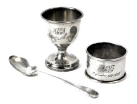 A George V silver Christening set, comprising egg cup, spoon and napkin ring, each engraved AEJ Sept