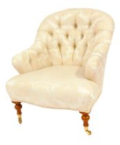 A 20thC armchair, upholstered in cream foliate pattern fabric, with a curved button back, shaped fro