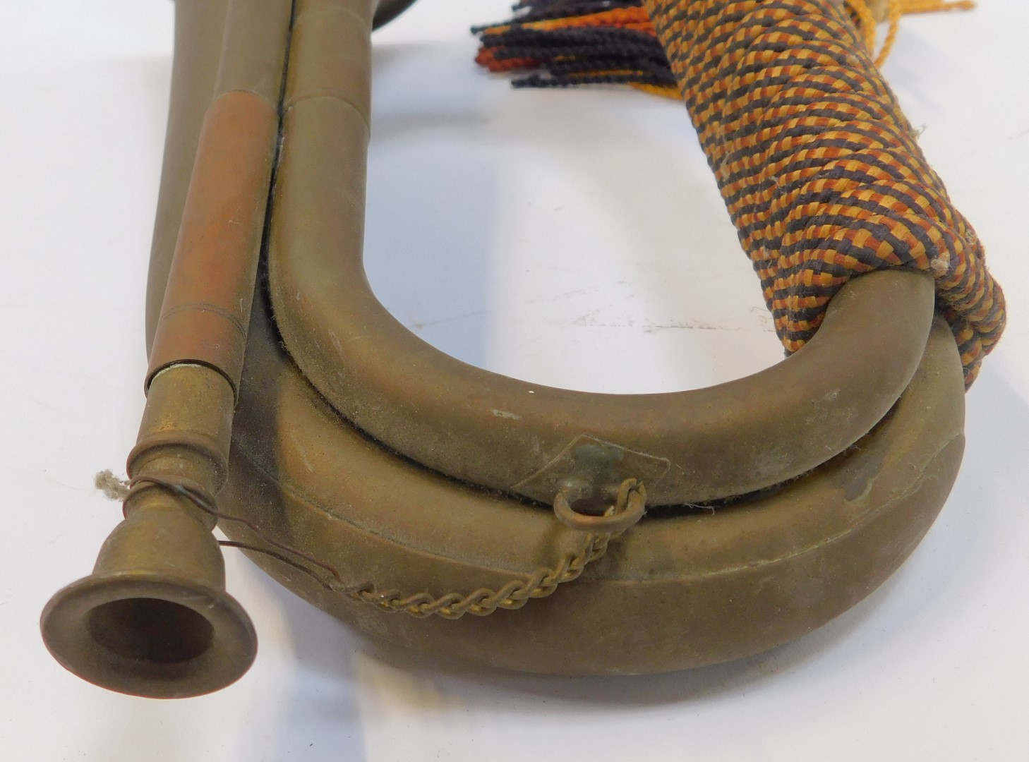 A copper and brass bugle, with orange, yellow and blue rope work frogging, 29cm long. - Image 3 of 3