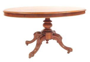 A Victorian mahogany breakfast table, the oval top with a moulded edge, raised on a turned column, o