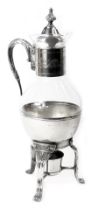 An early 20thC French silver plated claret jug, with foliate engraved collar, glass bowl and rim, on