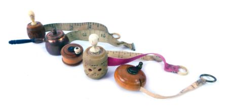 A group of 19thC and later tape measures, to include a measure modelled as a butter churn, 2.3cm dia