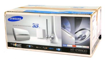 A Samsung 3D/DVD home entertainment system, HT-ES6600, with sub woofer and bottle speakers, in white