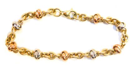 A bicolour bracelet, the knotted links in rose and white gold, with yellow gold curb links, 18cm lon