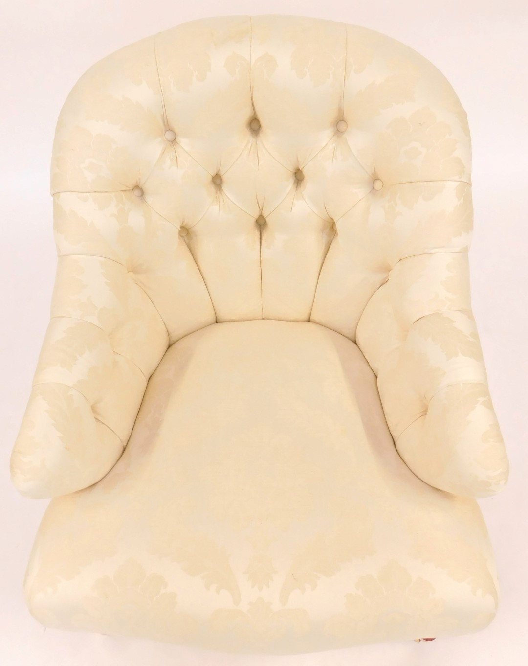 A 20thC armchair, upholstered in cream foliate pattern fabric, with a curved button back, shaped fro - Image 2 of 2