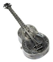 A novelty guitar pill box, formed in the shape of a guitar, the base opening, white metal, London 19