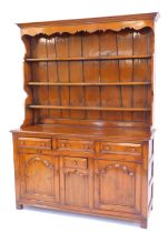 An oak Welsh dresser in 18thC style, the top with a moulded edge with three shelves, the base with t
