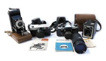 A group of cameras, comprising a Kodak folding camera F6.3, a Kodak Brownie model D camera, in canva