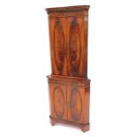 A Reprodux mahogany and flamed mahogany standing corner cabinet, the top with a dentil moulded edge