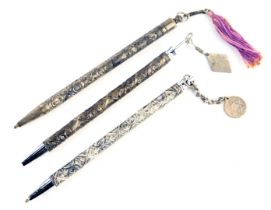 Three Israeli ballpoint pens, each with embossed decoration in white metal depicting floral motifs,