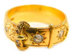 A Victorian buckle ring, set with two large old cut diamonds and five small old cut diamonds, each i