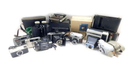 A group of camera and optics, to includea Halina Rolls camera, cased binoc