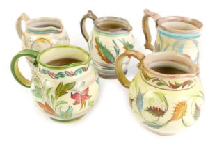 Five Denby Glynn Colledge jugs, each of rustic design painted with flowers, the largest 13cm high.