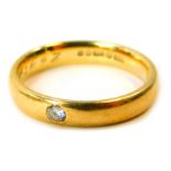 A 9ct gold diamond solitaire wedding band, set with a tiny diamond, inscribed 26 Years, ring size M½