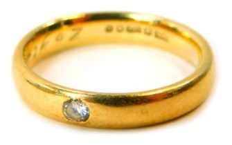 A 9ct gold diamond solitaire wedding band, set with a tiny diamond, inscribed 26 Years, ring size M½