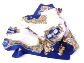 A 1960s/1970s silk scarf, on a blue ground with gold floral rococo style border, in the Hermes style