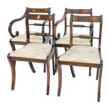 A set of four Reprodux mahogany dining chairs in Regency style, with turned rail back on sabre legs,