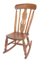 A late 19thC elm and beech lath back rocking chair, solid rail and pierced splats, solid seat, on tu