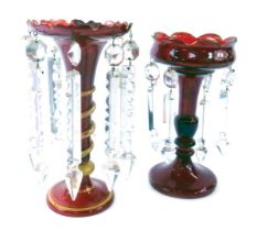 Two similar late 19thC ruby glass lustres, each with a turreted top, on a twisted and gilded stem, o