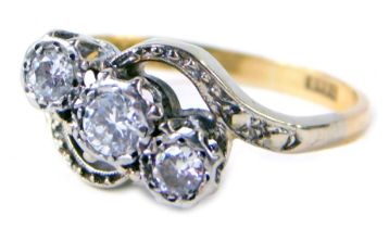 An 18ct gold diamond twist ring, set with three round brilliant cut diamonds each approx 0.1cts and