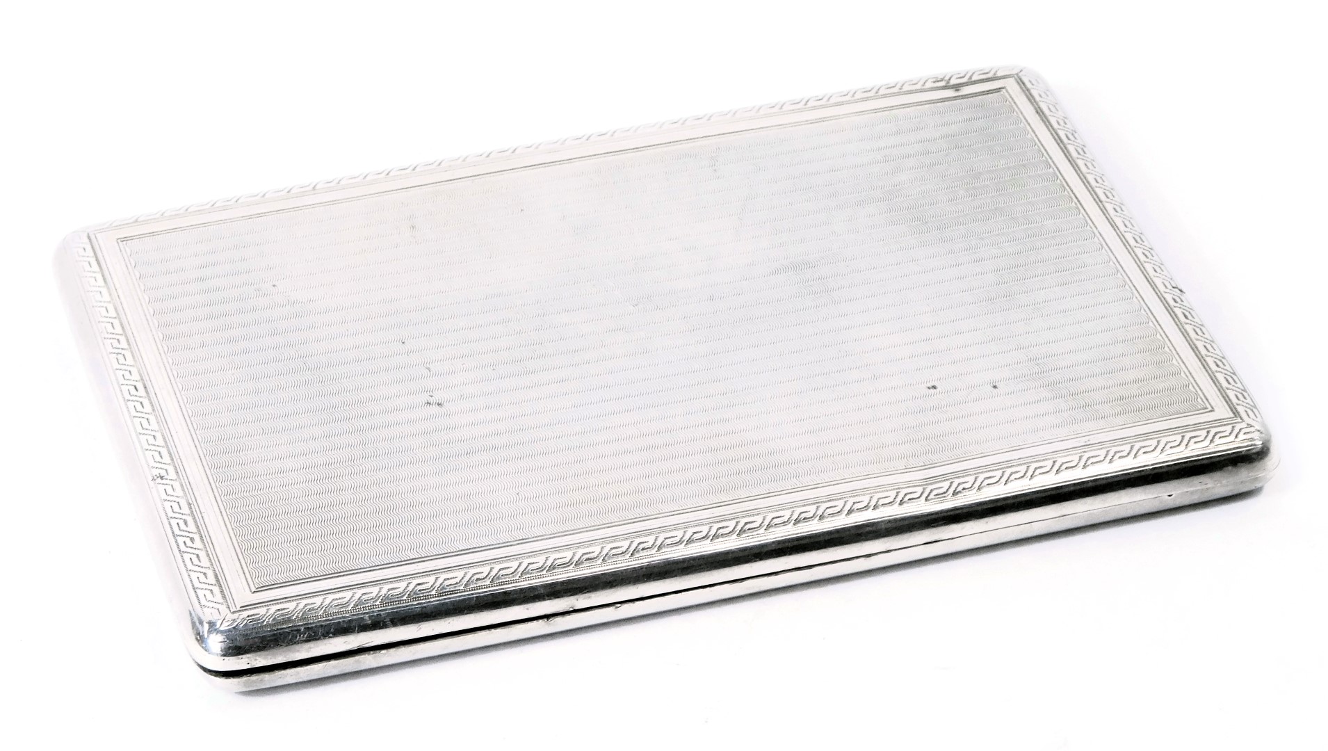 A George V silver cigarette case, of rectangular form with engine turned engraved striped decoration