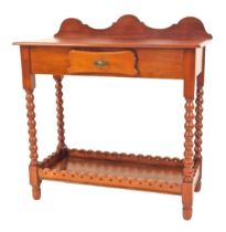 An early 20thC mahogany side table, with a raised shaped back, frieze drawer, raised on bobbin turne