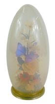 After Michael Curzon. A flower and butterfly display, with opaline glass dome, on Perspex foot, bear