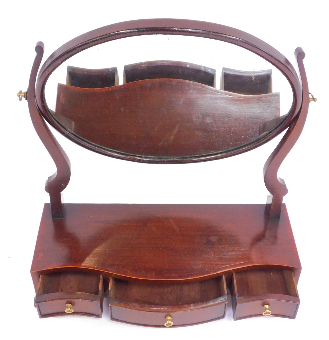 A 19thC swing frame toilet mirror, the oval mirror mounted on two scroll supports, on a shaped base, - Image 2 of 2