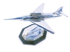 A vintage chrome jet plane cigarette lighter with chrome finish, modelled as a plane on swivel perch
