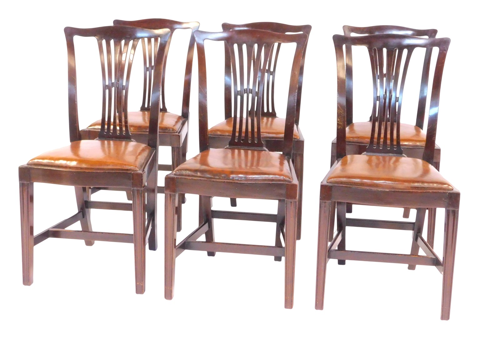 A set of six Edwardian mahogany dining chairs, each with a pierced vase shaped splat, brown leather
