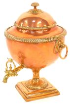 A Victorian brass and copper tea urn, globular form with a brass reeded border and ring handles, on