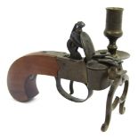A novelty flintlock pocket pistol table lighter, with brass candle holder, 13cm long.