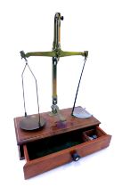 A Cooperative Wholesale Society brass scales, on wooden base with a group of weights and two glass c