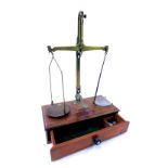 A Cooperative Wholesale Society brass scales, on wooden base with a group of weights and two glass c