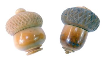 Two 19thC wooden thimble cases, modelled as acorns, each with a screw top, 4.7cm and 5.3cm high.